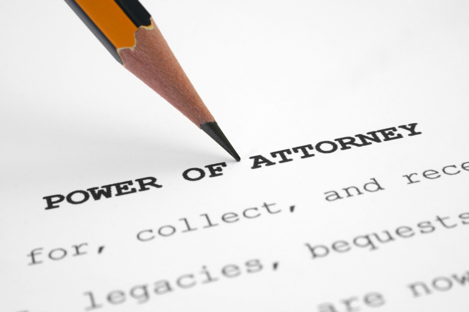 "Power of Attorney" written on the top of a legal document, with a pencil pointing to the title; our Lasting Power of Attorney solicitors in Preston discuss LPAs and who signs the final documents.