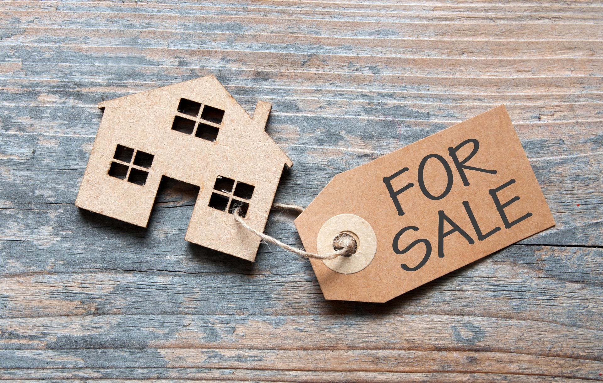 A small cut out house, with a for sale tag tied on; our Conveyancing Solicitors in Preston discuss different methods of selling property and which one may be suited to you.