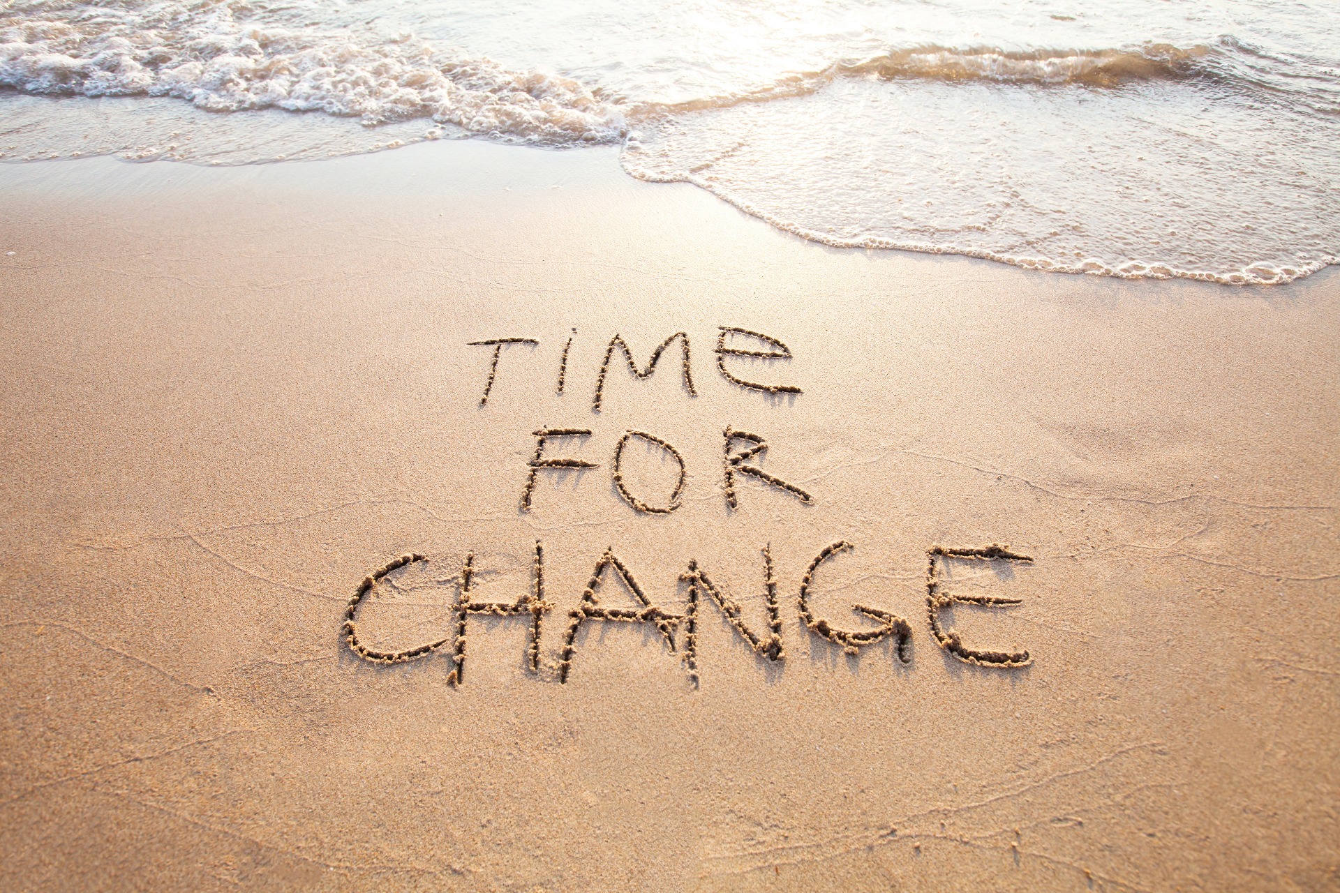"Time for Change" written in the sand of a beach; our Wills Solicitors page, which can be viewed by clicking this image, discuss when to update your Will, and how we can assist.