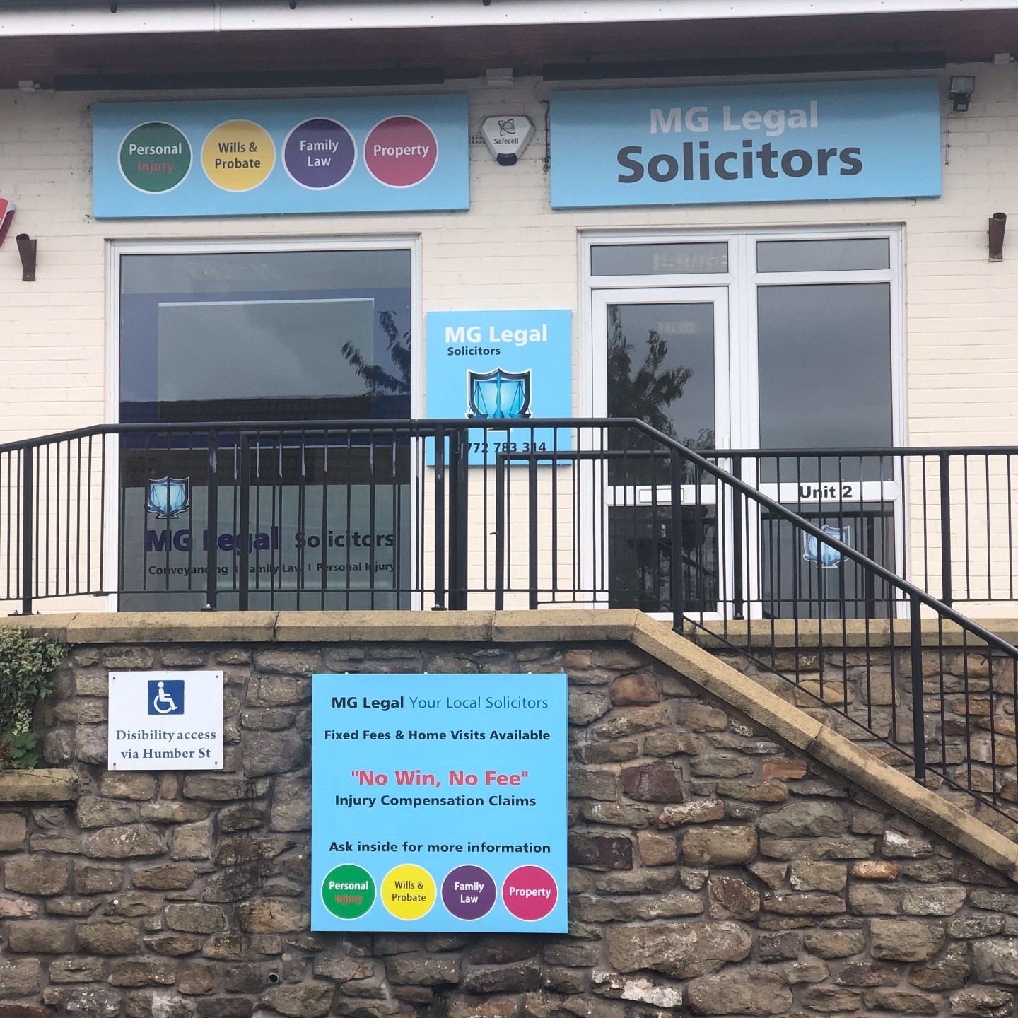 The exterior of our Longridge office on Calder Avenue, Longridge, PR3 3HT, with our blue information sign, and our contact information.