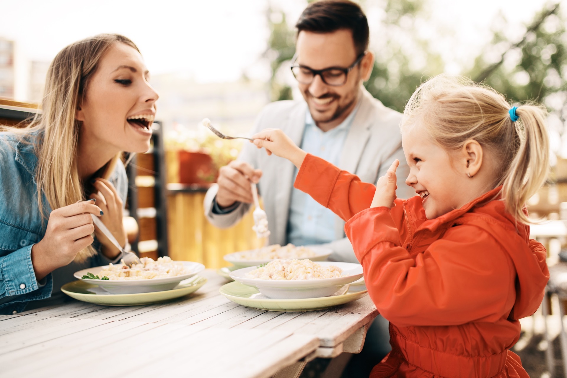 Three people sharing a meal of pasta; our Allergy Compensation Solicitors discuss No Win No Fee compensation claims for coeliac allergy claims.