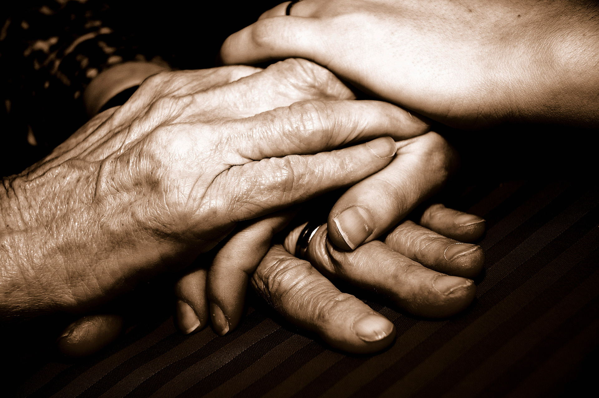 An older couple clasping hands.
