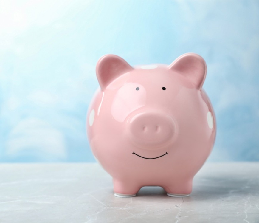 A pink piggy bank, on a blue background; our Commercial Conveyancing Solicitors' fees can be found by following this link.