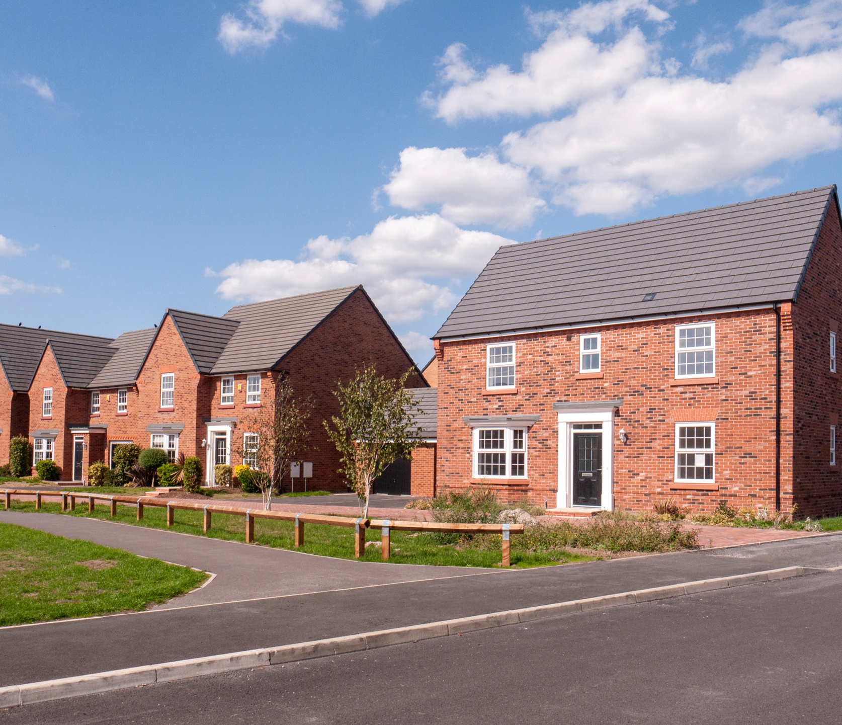 A row of new build houses, with a link to our Conveyancing Solicitors' page for First Time Buyers.