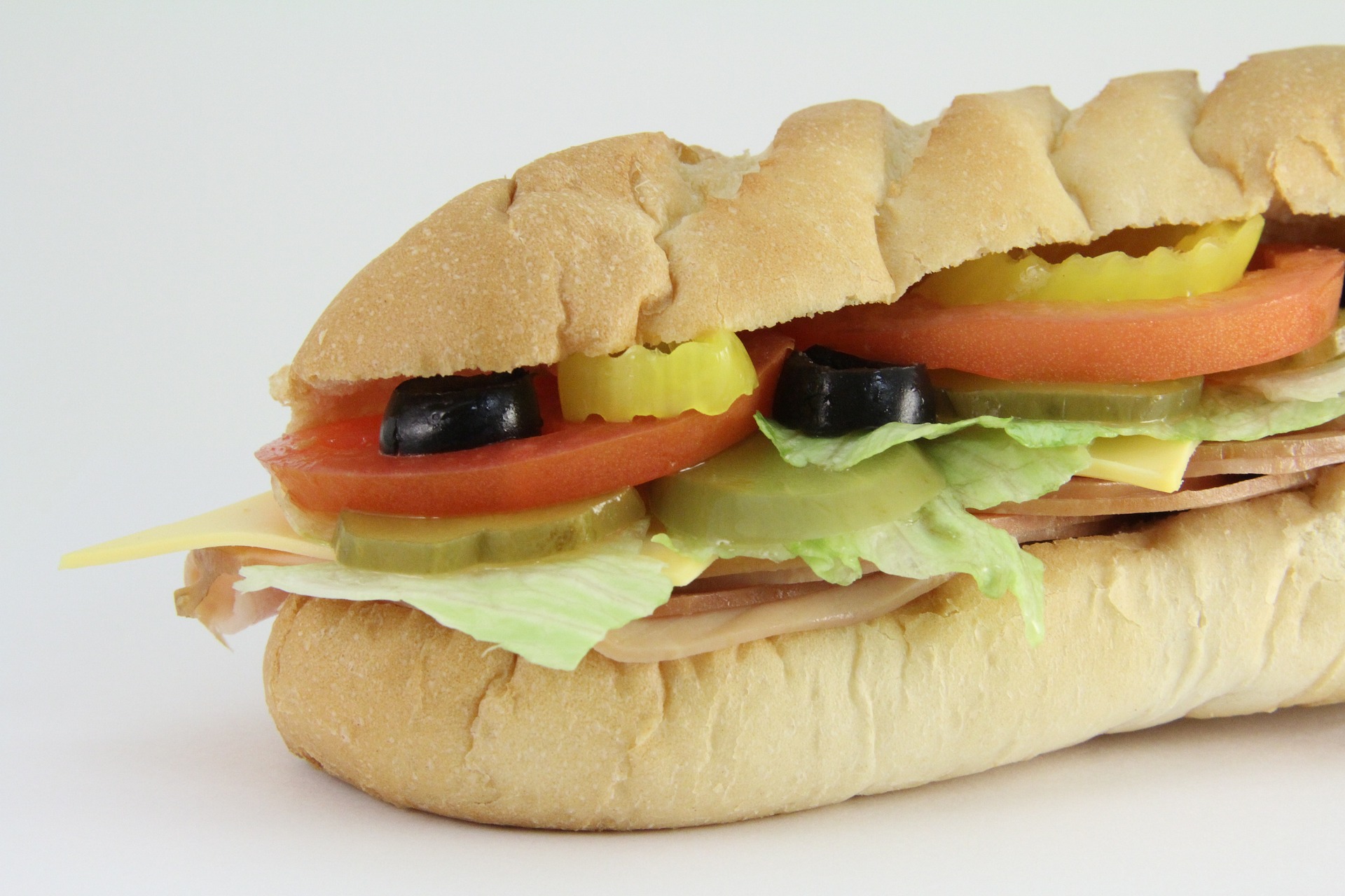 A subway sandwich with tomatoes, olives and deli meat, which contains Sulphites; our sulhpite allergy compensation solicitors can assist you with making a compensation claim.  Click this picture to read more about sulphite allergy compensation claims.