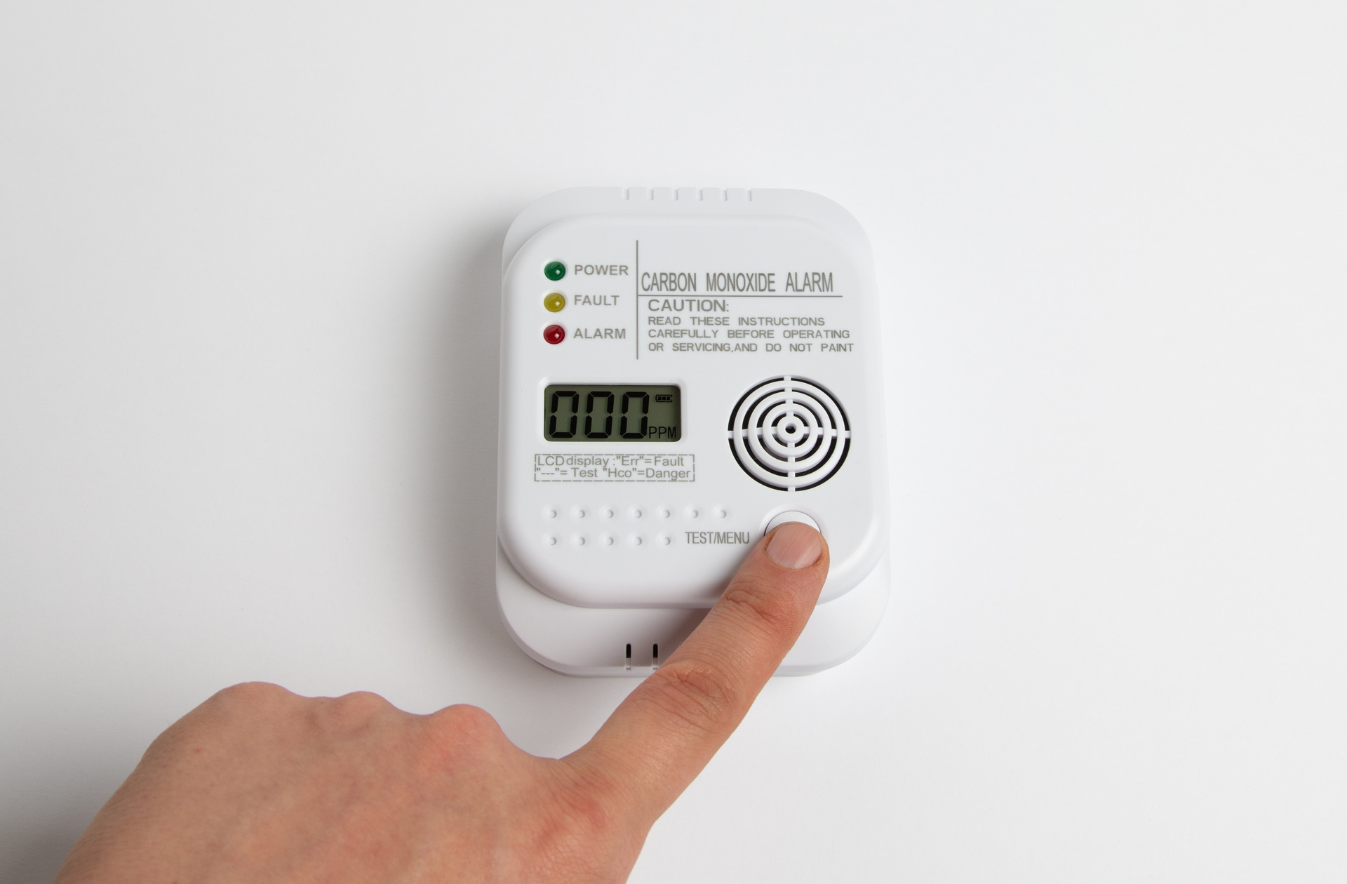 A person touching the test button on a Carbon Monoxide alarm.  Click the picture, or the link below, to go to our personal injury solicitors’ no win no fee carbon monoxide negligence claims page.