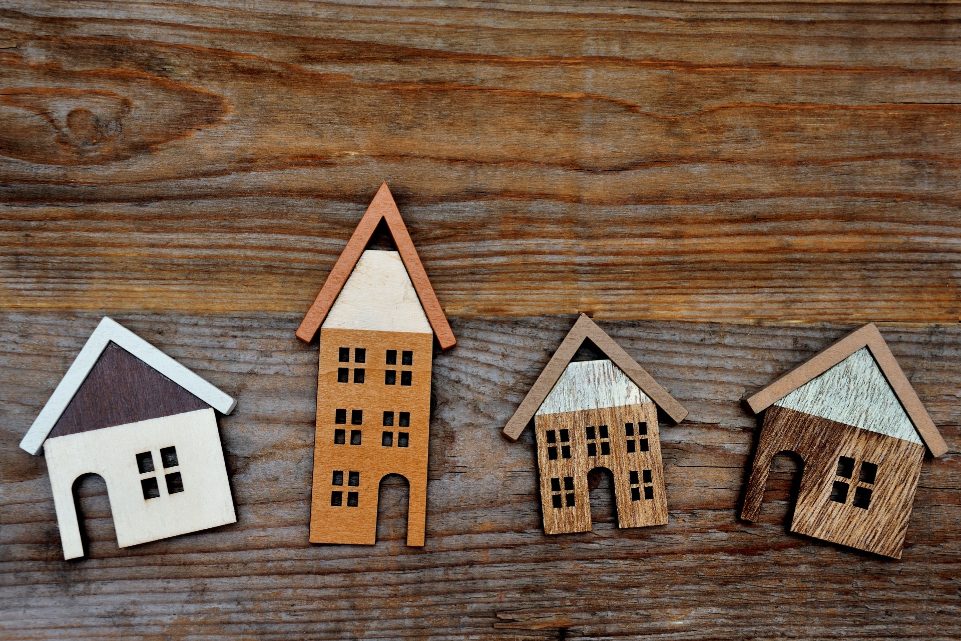 Selection of Wooden Houses on a Wooden Background
