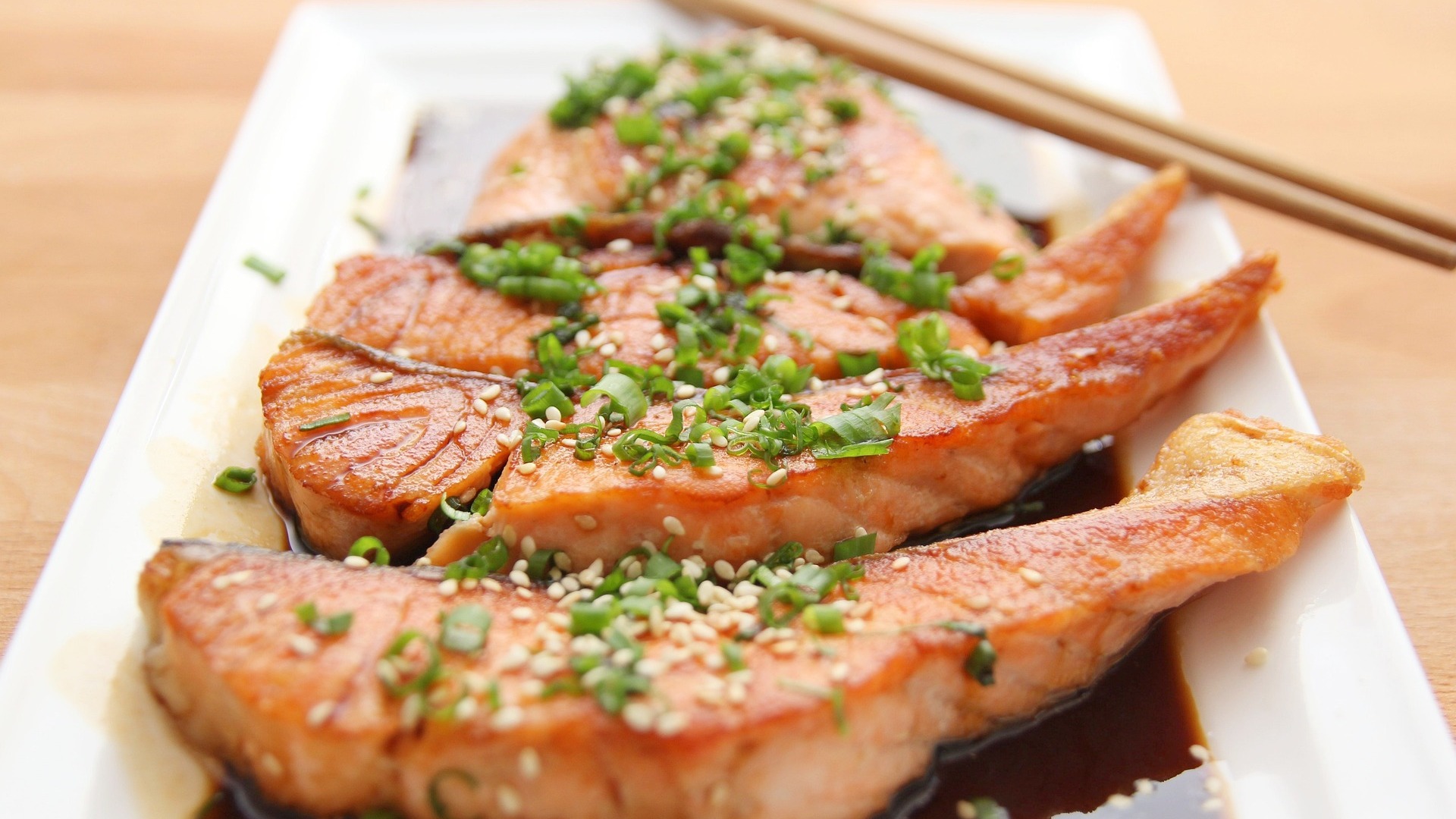 Raw fish with sesame seeds and spring onion, with a sauce; raw fish is a common cause of food poisoning, which our No Win No Fee solicitors can assist with a claim for.