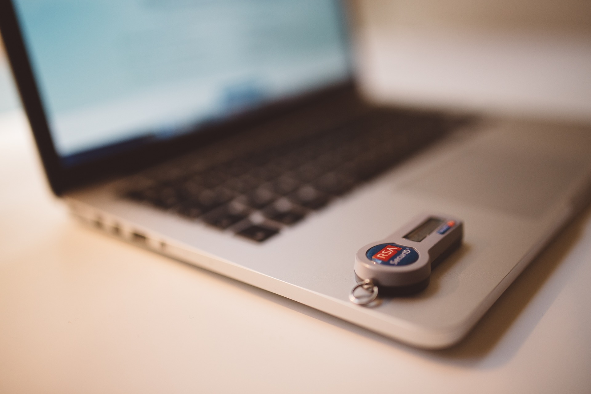 A laptop, with a pen drive / USB stick resting on top; our Conveyancing Solicitors in Lytham discuss ID requirements when buying or selling property to reduce fraud.
