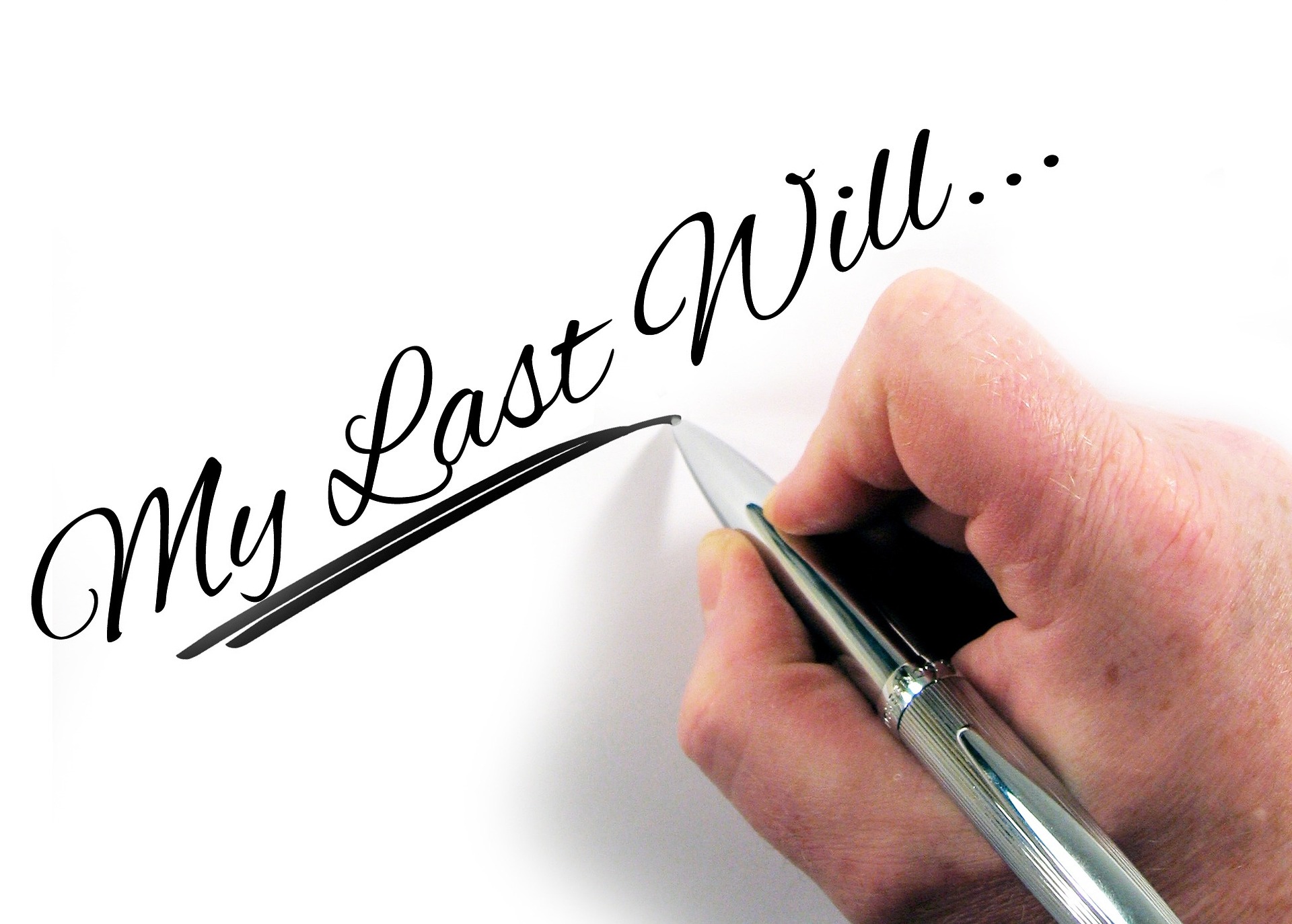 "My Last Will" written in ink, with a person holding a pen; our Wills Solicitors can assist with the preparation of your Will.