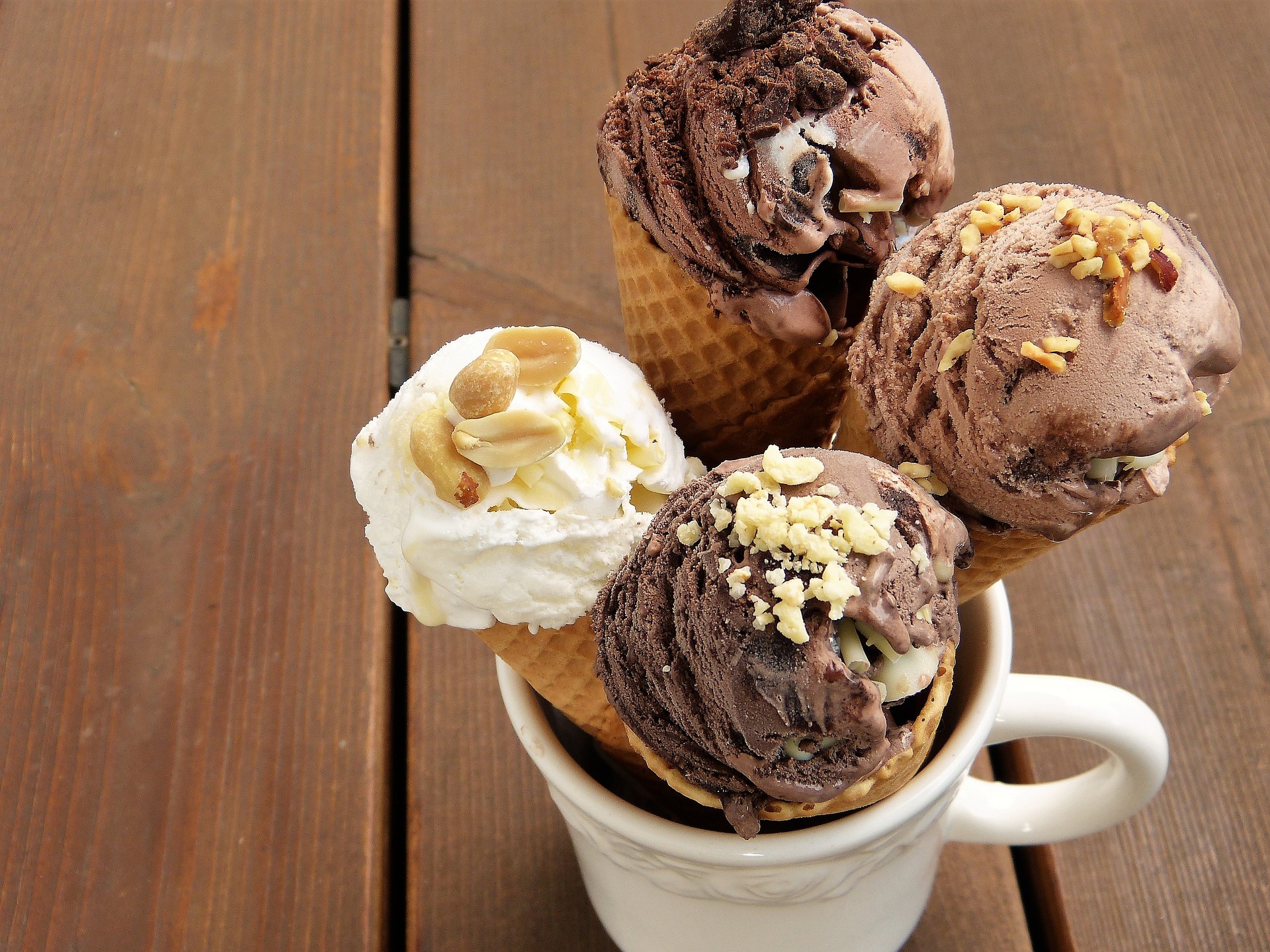 Four icecreams, topped with nuts, in a mug.  Our No Win No Fee Allergy compensation solicitors can assist with making a No Win No Fee compensation claim if you've suffered from an allergic reaction due to undisclosed allergens.