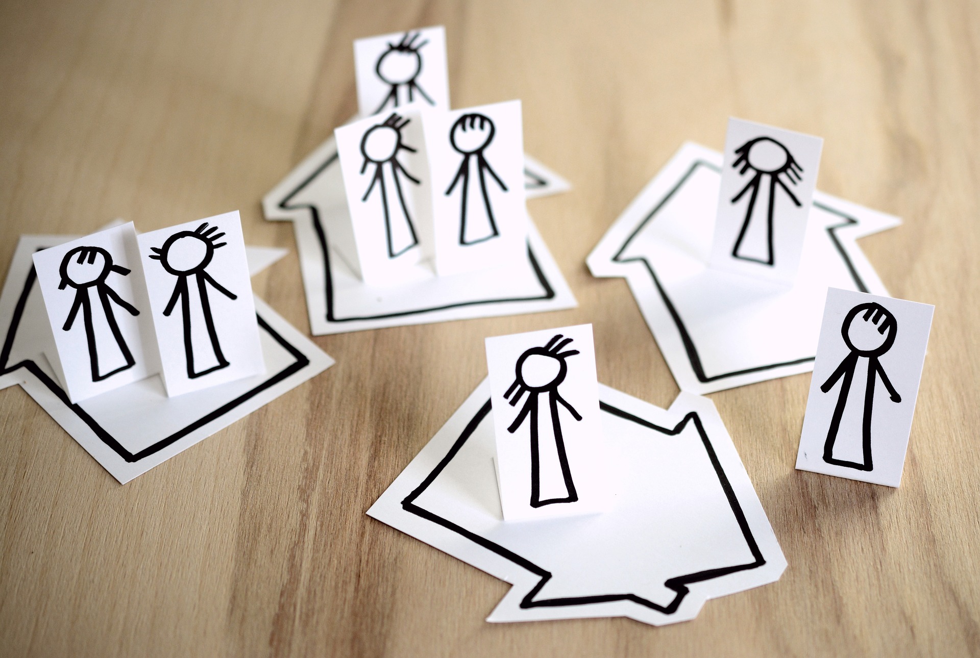 Paper cut-outs of people, placed on top of cut outs of different houses; our Probate Solicitors in Preston discuss the intestacy rules and how we can assist with your loved one's estate.