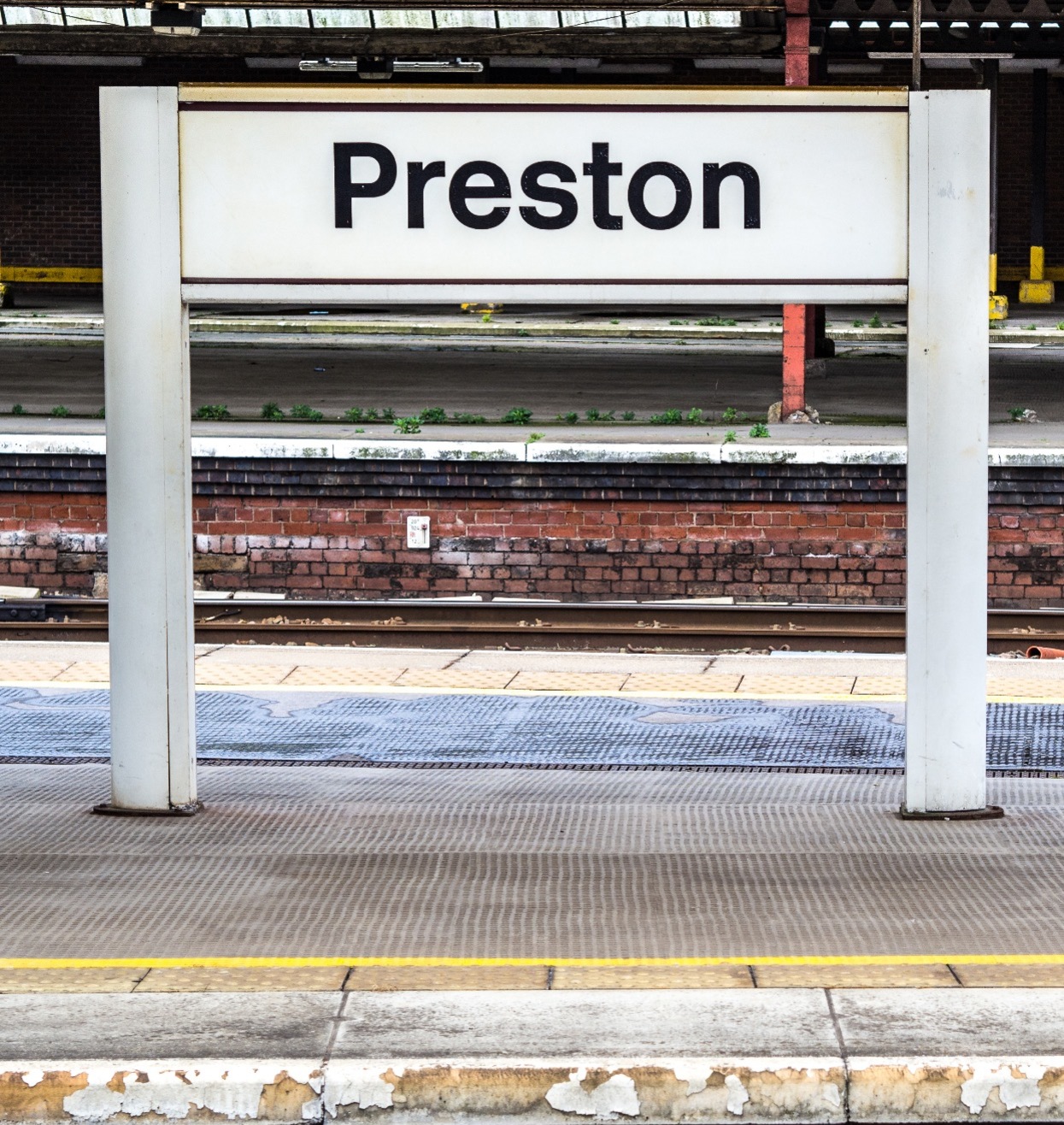 A sign at Preston Train Station stating "Preston"; our No Win No Fee Solicitors in Preston can assist with your injury compensation claim.