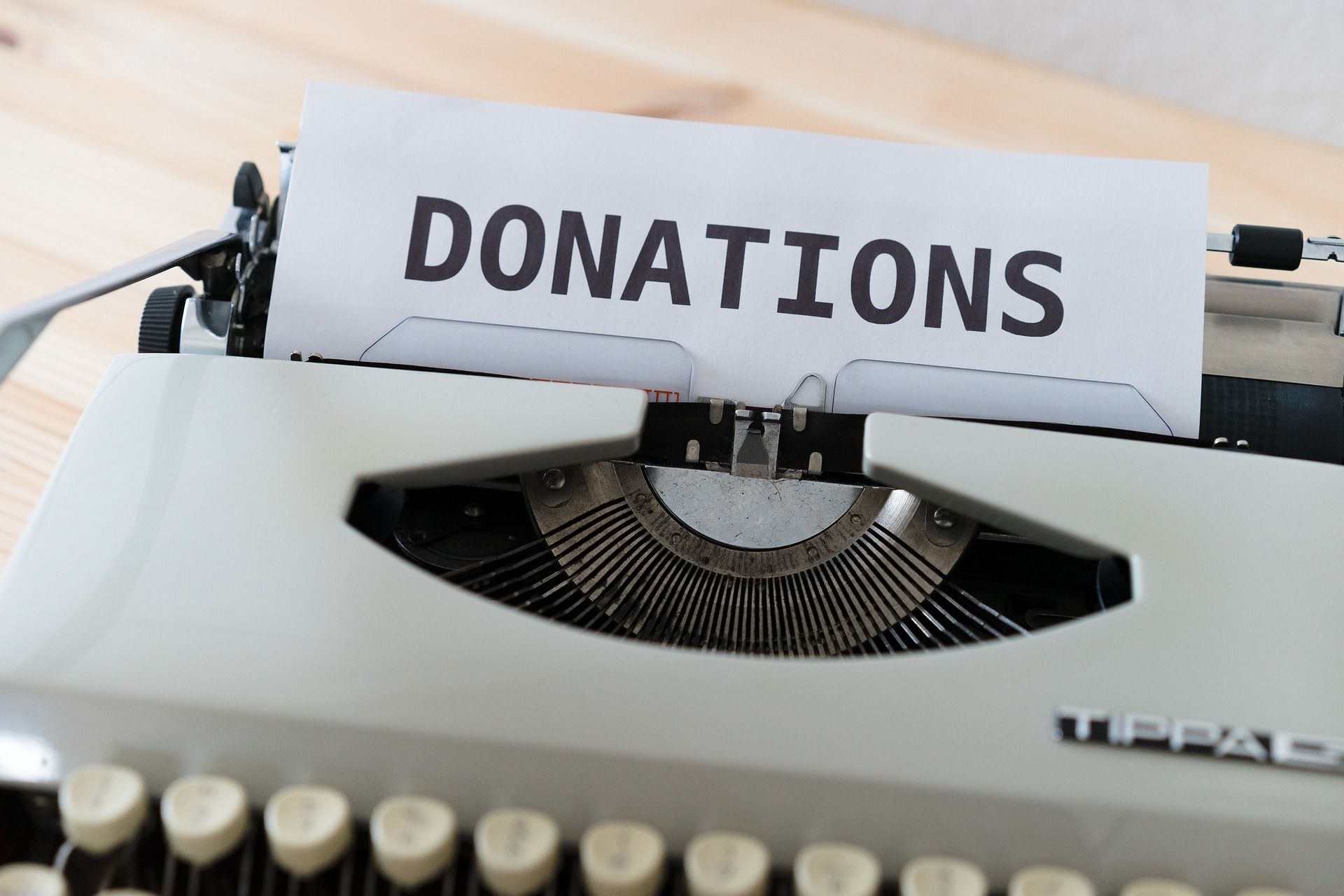 A typewriter with the word "Donations" written on; our Wills Solicitors in Preston discuss including charitable donations in your Will.