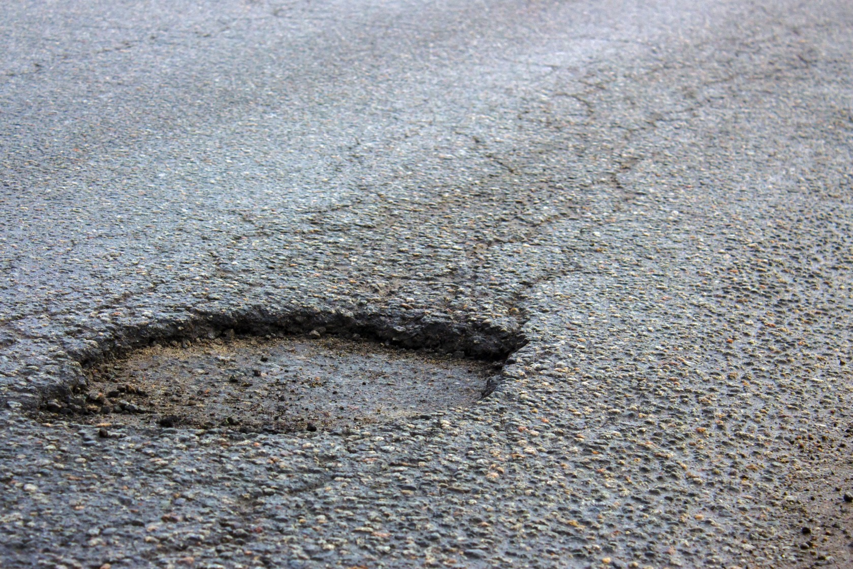 A large pothole in a road.