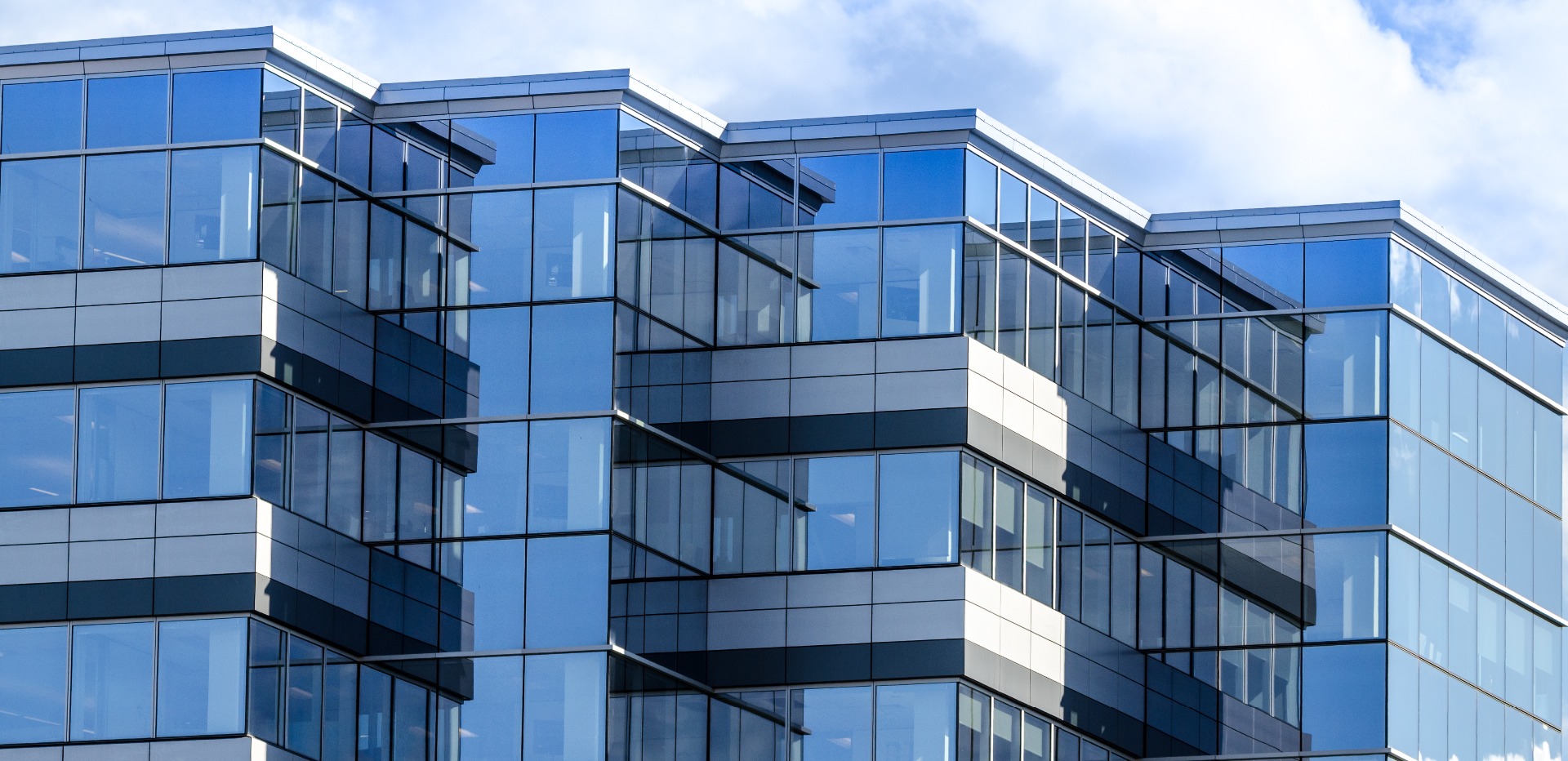 A large, building with all glass windows; a typical commercial property.  Our Commercial Conveyancing Solicitors in Preston can assist with your commercial matter.