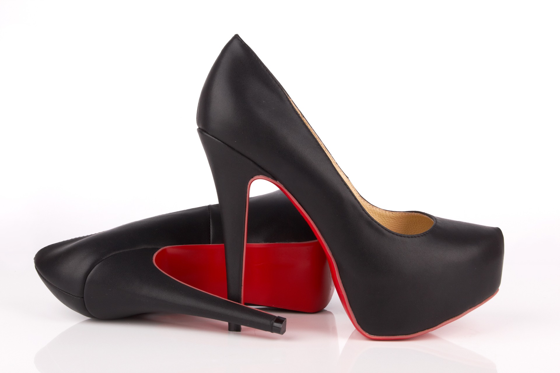 A pair of black heels with a red base