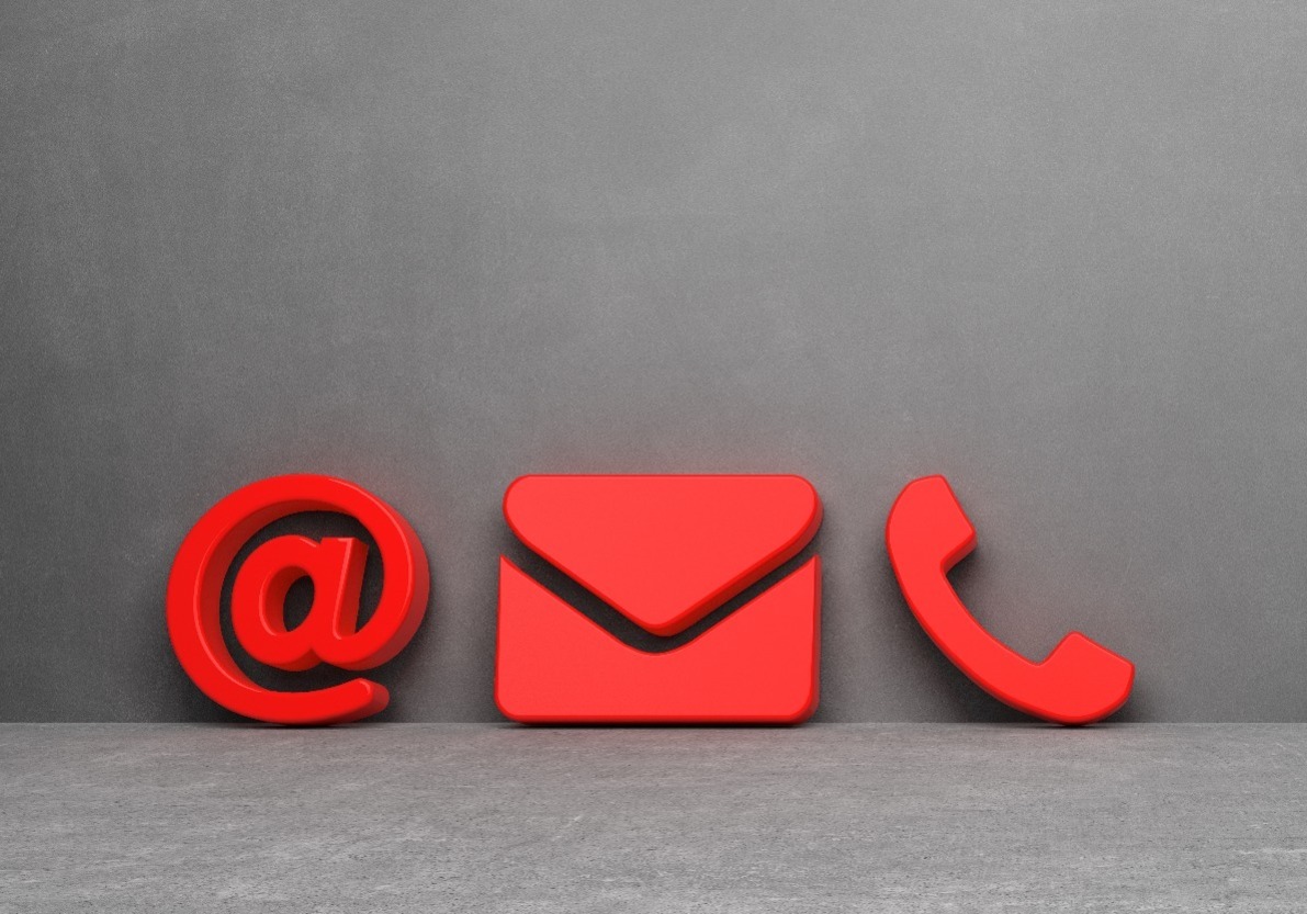 An @ symbol, an envelope and a telephone, in red, against a grey background.