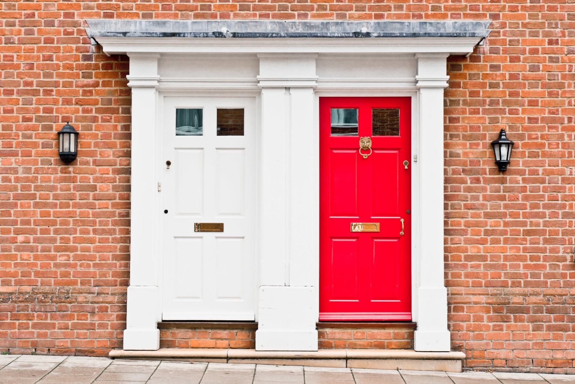 A house with two front doors, one white and one red.