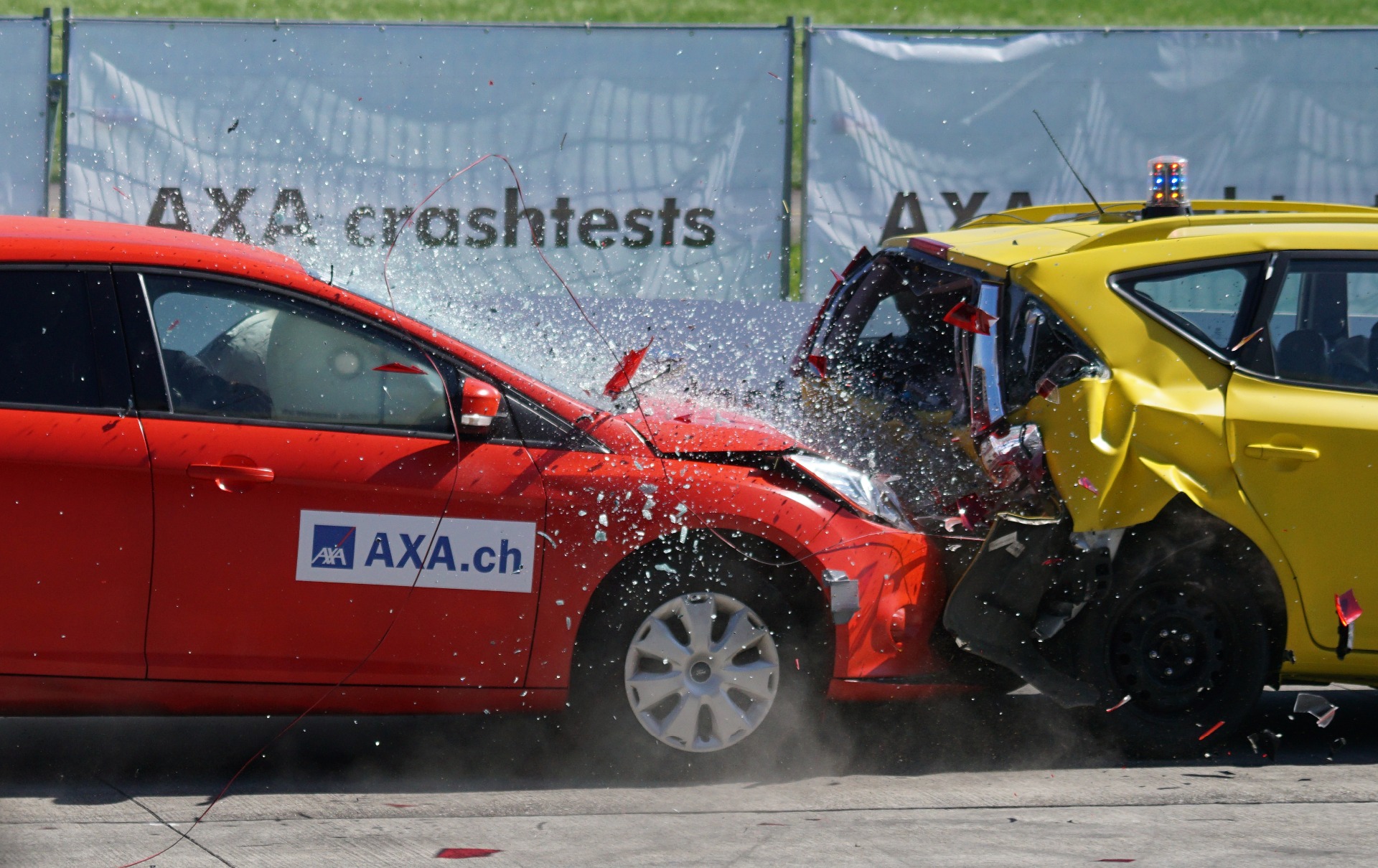 A red car crashing into the back of a yellow car.