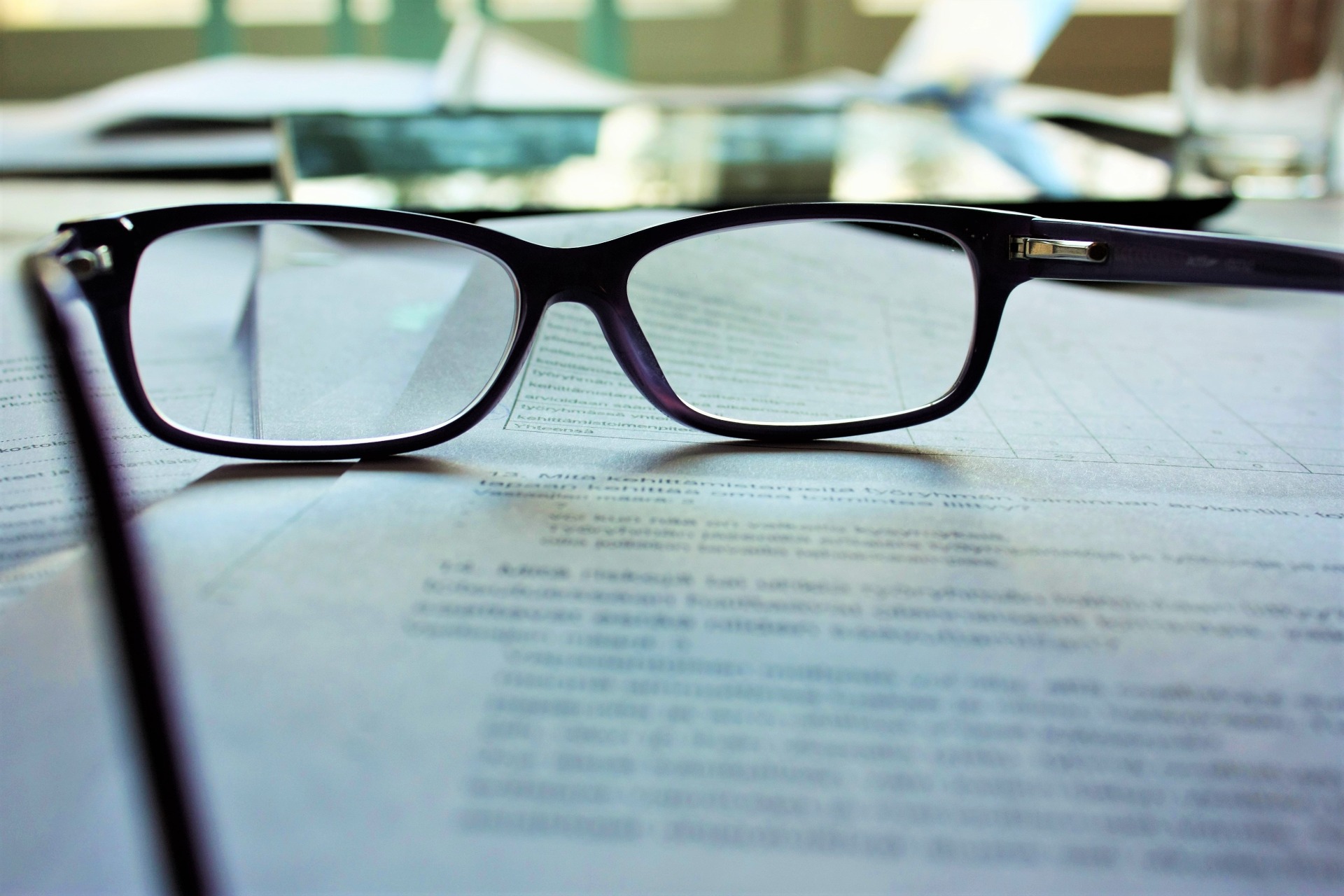 A pair of glasses resting on a legal document.